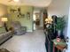 Cozy living room with a comfortable sofa, recliner, neutral carpeting, and decorative shelves and lighting at 2715 Prosperity Dr, Columbus, IN 47201