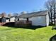 Spacious backyard featuring a well-maintained lawn and a wooden deck perfect for entertaining at 305 S Schroeder Rd, Muncie, IN 47304