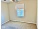 Neutral bedroom with a bright window bringing in natural light, complete with carpeting and painted walls at 305 S Schroeder Rd, Muncie, IN 47304