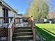 Exterior view of a wooden deck with stairs, offering a nice outdoor space at 305 S Schroeder Rd, Muncie, IN 47304
