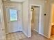 Welcoming entryway featuring tile floors, a decorative front door, and access to various rooms in the home at 305 S Schroeder Rd, Muncie, IN 47304