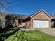 Well-maintained brick home with attached garage and pristine lawn at 305 S Schroeder Rd, Muncie, IN 47304