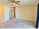 Inviting living area with neutral walls and plush carpeting, creating a cozy atmosphere at 305 S Schroeder Rd, Muncie, IN 47304