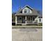 Charming two-story home with a covered front porch and well-maintained exterior at 312 S Gharkey St, Muncie, IN 47305