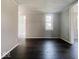 Neutral-colored living room featuring hardwood floors and freshly painted walls at 312 S Gharkey St, Muncie, IN 47305