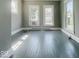 Bright living space with large windows and painted hardwood flooring at 312 S Gharkey St, Muncie, IN 47305