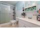Bathroom featuring a glass-enclosed shower, toilet and vanity with cabinet and shelves for storage at 350 Springfield Cir, Greenwood, IN 46143