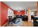 Inviting living space with a dining table, a comfortable black sofa, and warm, natural lighting at 350 Springfield Cir, Greenwood, IN 46143