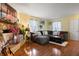 Comfortable living room with a stone fireplace, plush seating, and hardwood floors, perfect for relaxing and entertaining at 350 Springfield Cir, Greenwood, IN 46143