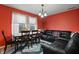 Cozy living area with a dining table and a black leather couch, illuminated by natural light from the windows at 350 Springfield Cir, Greenwood, IN 46143