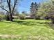 Large grassy backyard showing fresh mowing pattern at 3601 N Oakwood Ave, Muncie, IN 47304