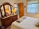 Bedroom featuring natural light, a bed, dresser, and vanity at 3601 N Oakwood Ave, Muncie, IN 47304