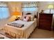 Cozy bedroom with a comfortable bed, dresser, and soft natural lighting at 3601 N Oakwood Ave, Muncie, IN 47304