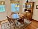 Charming dining area with a wooden table, chairs, hutch, and a decorative rug at 3601 N Oakwood Ave, Muncie, IN 47304