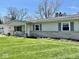 Charming single-story home with tidy landscaping and a stone accent along the front of the house at 3601 N Oakwood Ave, Muncie, IN 47304