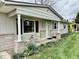 Cozy front porch area featuring two chairs and landscaping at 3601 N Oakwood Ave, Muncie, IN 47304