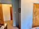 Hallway featuring blue walls, wood trim, and view into another room at 3601 N Oakwood Ave, Muncie, IN 47304