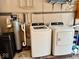 Laundry area with washer, dryer, and water filtration system at 3601 N Oakwood Ave, Muncie, IN 47304