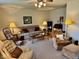 Cozy living room featuring carpet, ceiling fan, and lamps at 3601 N Oakwood Ave, Muncie, IN 47304