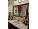 Elegant bathroom featuring a framed mirror, updated fixtures, and stylish decor at 3614 Thorncrest Dr, Indianapolis, IN 46234
