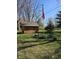 Well-maintained yard with a shed and a flagpole displaying the American flag at 3614 Thorncrest Dr, Indianapolis, IN 46234