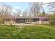 Back exterior view of home with a patio and a landscaped yard at 3636 E 71St St, Indianapolis, IN 46220
