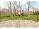 Backyard patio with a playset and shed, surrounded by trees at 3636 E 71St St, Indianapolis, IN 46220