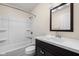 Bathroom with a shower-tub combo, dark wood vanity, and black and white tile floors at 3636 E 71St St, Indianapolis, IN 46220