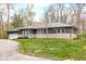 Ranch home featuring stone accents and a lush front lawn at 3636 E 71St St, Indianapolis, IN 46220