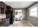 Bright kitchen with a glimpse into the other rooms, featuring stone floors and dark cabinets at 3636 E 71St St, Indianapolis, IN 46220