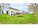 Large backyard with a lush lawn, wood deck, a trampoline, and a glimpse of neighboring homes at 3724 Jonathan Rdg, Columbus, IN 47201