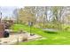 Expansive backyard featuring a basketball hoop, trampoline, and lush green grass, ideal for outdoor activities at 3724 Jonathan Rdg, Columbus, IN 47201