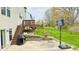 View of backyard from patio with basketball hoop, gas grill, and stairs leading to a wooden deck at 3724 Jonathan Rdg, Columbus, IN 47201