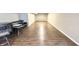 Finished basement featuring vinyl flooring, a small couch and table, and a soccer net in the background at 3724 Jonathan Rdg, Columbus, IN 47201