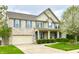 Charming two-story brick home with blue shutters, a covered porch, well-kept lawn, and attached garage at 3724 Jonathan Rdg, Columbus, IN 47201