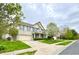 Charming two-story brick home with blue shutters, a covered porch, well-kept lawn, and attached garage at 3724 Jonathan Rdg, Columbus, IN 47201