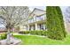 Two-story home showcasing meticulous landscaping, a brick facade, a covered porch, and a well-manicured lawn at 3724 Jonathan Rdg, Columbus, IN 47201