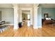 Open-concept living space with gleaming hardwood floors, decorative pillars, and an inviting flow throughout the home at 3724 Jonathan Rdg, Columbus, IN 47201