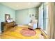 Inviting living room featuring hardwood floors, a comfortable armchair, natural light, and a piano at 3724 Jonathan Rdg, Columbus, IN 47201