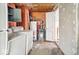 Shows the basement with visible pipes, an old water heater, washer, dryer, and an adjacent room at 3845 E 32Nd St, Indianapolis, IN 46218