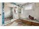 Damaged bathroom features a tiled shower with peeling paint and dated fixtures at 3845 E 32Nd St, Indianapolis, IN 46218