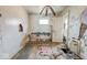 Bedroom in disrepair with peeling paint, damaged walls, and missing floor tiles at 3845 E 32Nd St, Indianapolis, IN 46218
