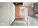 Shows the kitchen with unfinished walls, dated appliances, washer, dryer, and a partially visible window at 3845 E 32Nd St, Indianapolis, IN 46218