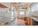 Shows the kitchen with outdated appliances, deteriorated ceiling, flooring, and a partially visible window at 3845 E 32Nd St, Indianapolis, IN 46218