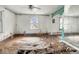 Shows a spacious living room featuring water damage, a window, and ornate mirrors at 3845 E 32Nd St, Indianapolis, IN 46218