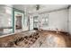 Shows a damaged living room featuring ornate mirrors, water damage, and a security door leading to the exterior at 3845 E 32Nd St, Indianapolis, IN 46218