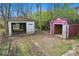 Backyard featuring two outbuildings, one partially open, on a lot with grass and dirt at 3845 E 32Nd St, Indianapolis, IN 46218