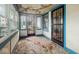 Shows the sunroom with its ornate security doors, windows, and a glimpse of the exterior at 3845 E 32Nd St, Indianapolis, IN 46218