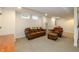 Cozy basement with a brown leather sofa, chair and ottoman on a carpeted floor at 402 E 46Th St, Indianapolis, IN 46205