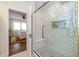 Bathroom view featuring a glass shower with tiled walls, and bedroom in the background at 402 E 46Th St, Indianapolis, IN 46205